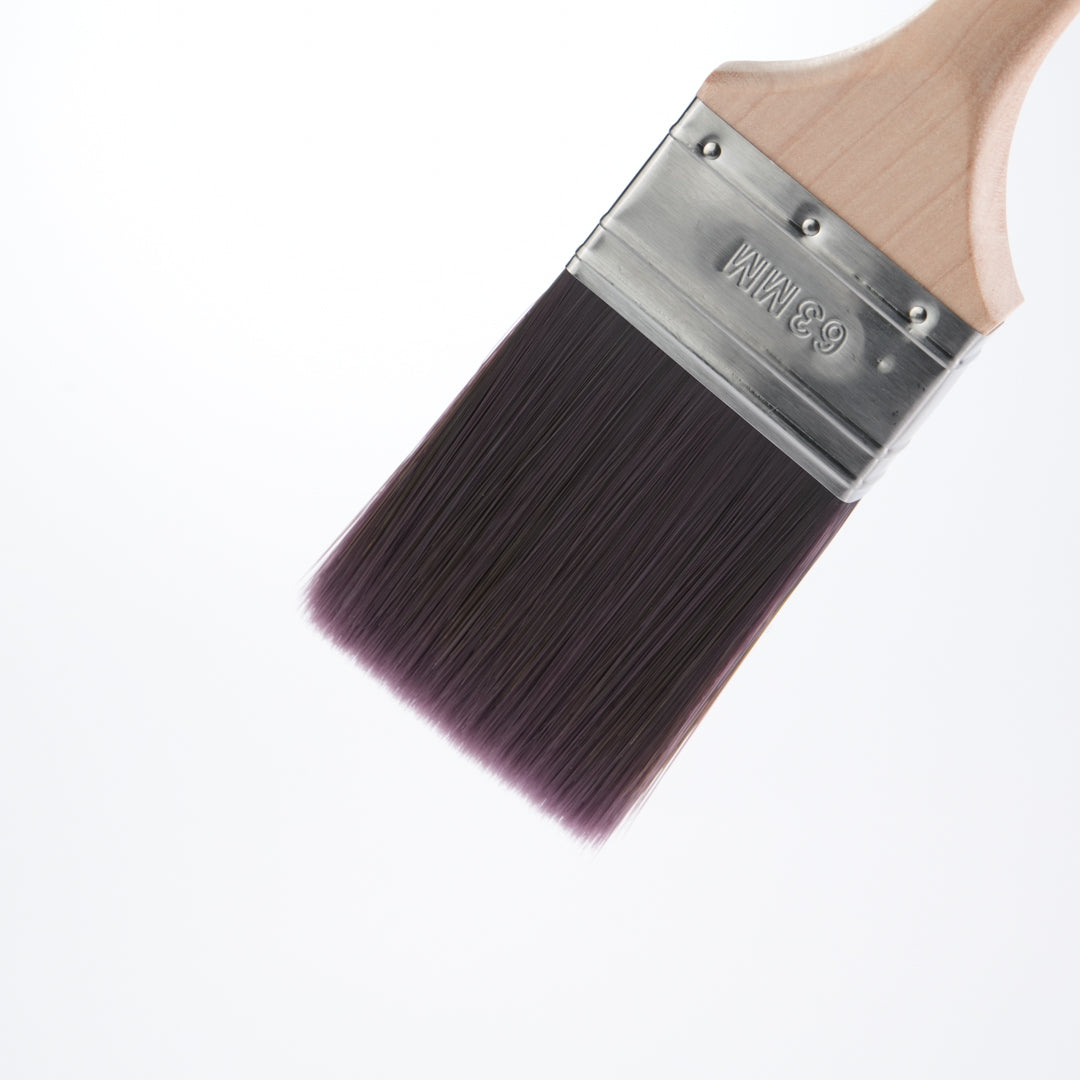 Close-up of Kibbu paint brush bristles and stainless steel ferrule on a white background