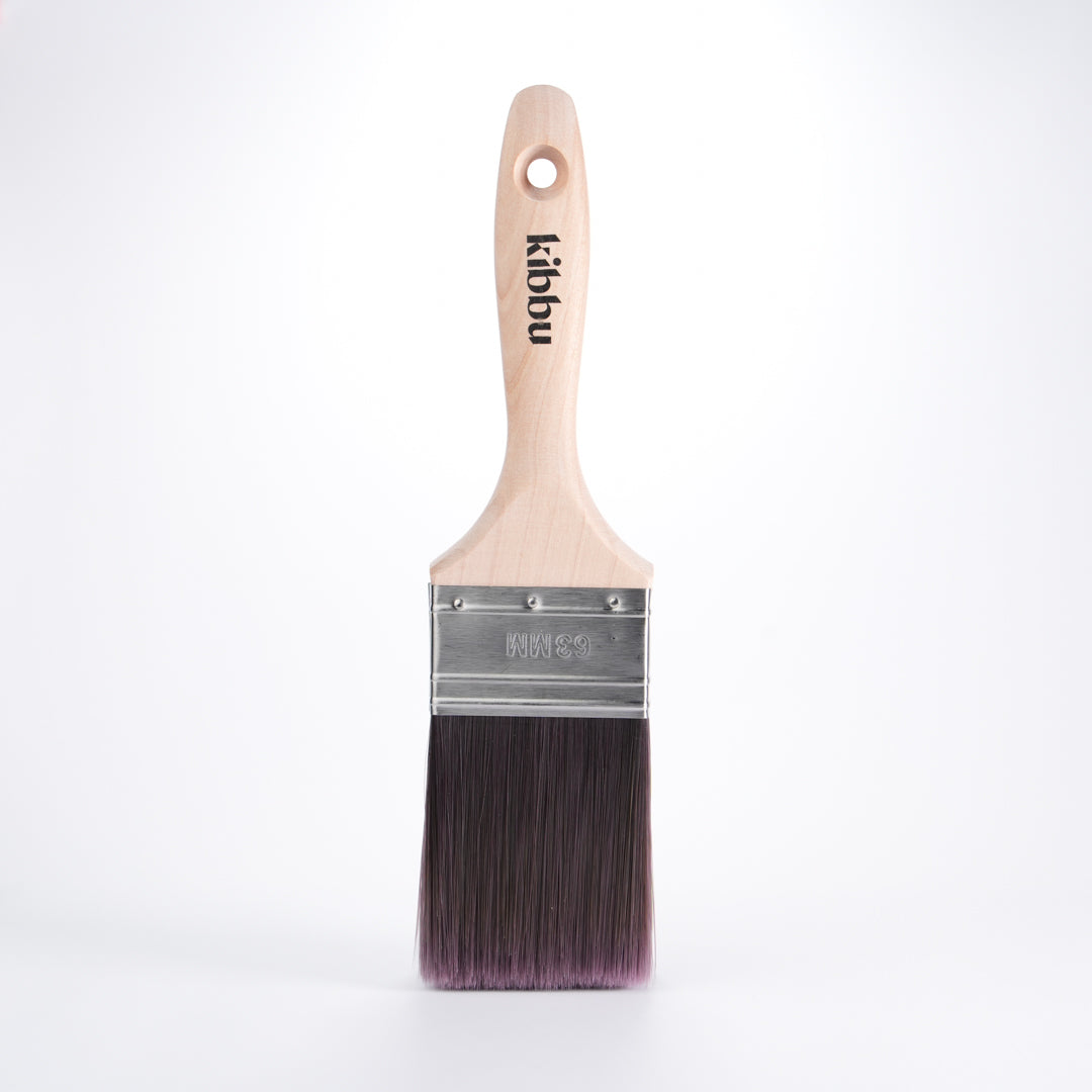 Kibbu paint brush with wooden handle and tapered synthetic bristles on a white background