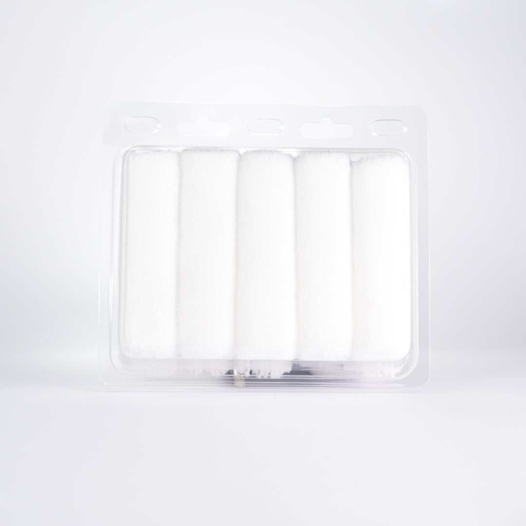 Rear view of Kibbu microfibre mini roller set showing five white 10mm nap mini rollers in clear plastic tray on a white background