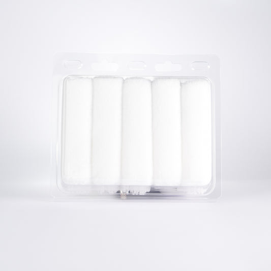 Rear view of Kibbu microfibre mini roller set showing five white 10mm nap mini rollers in clear plastic tray on a white background